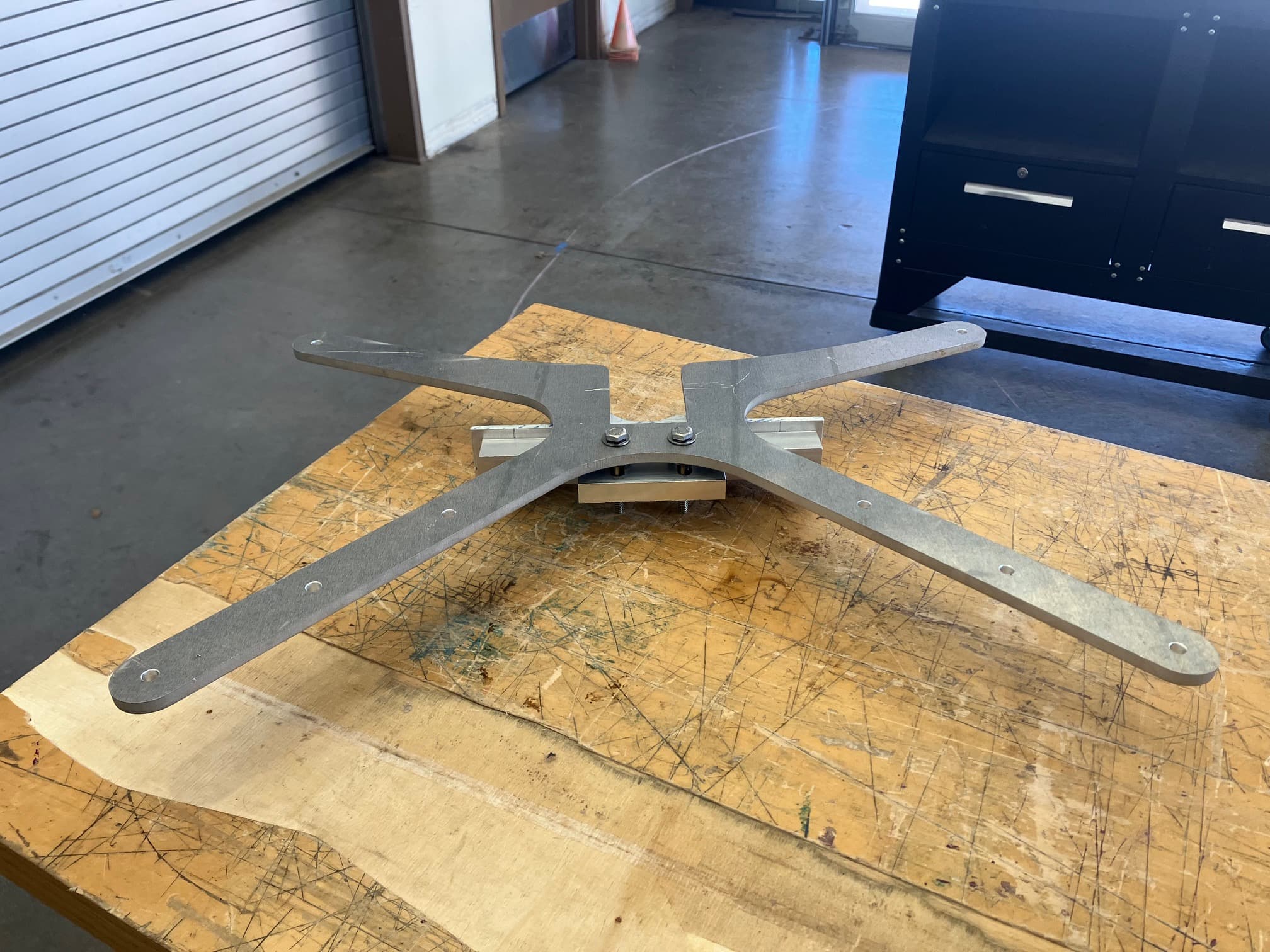 Wind turbine shroud baseplate and removable attachment hardware
