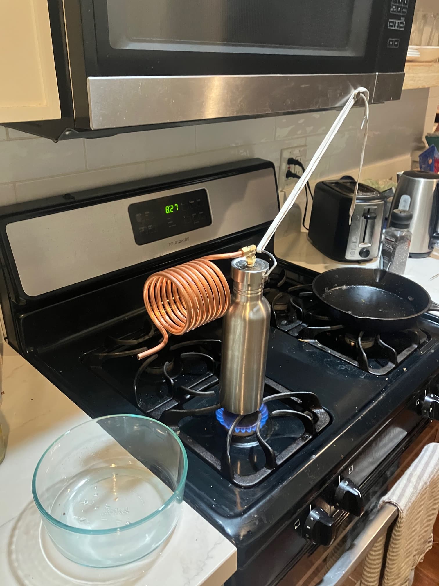 Compact desalination kit undergoing testing on a kitchen stove