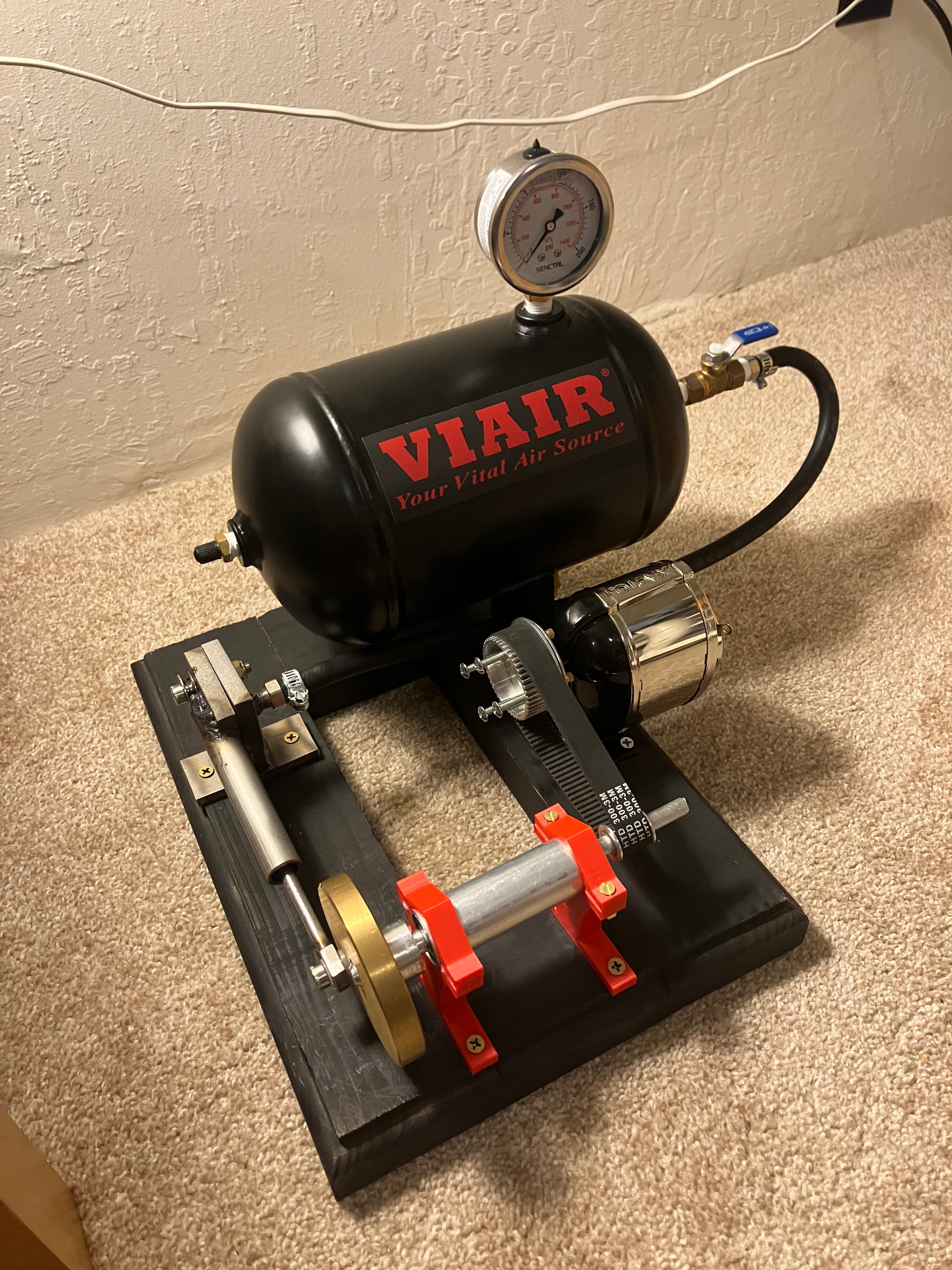 Completed compressed-air engine with belt-driven pencil sharpener