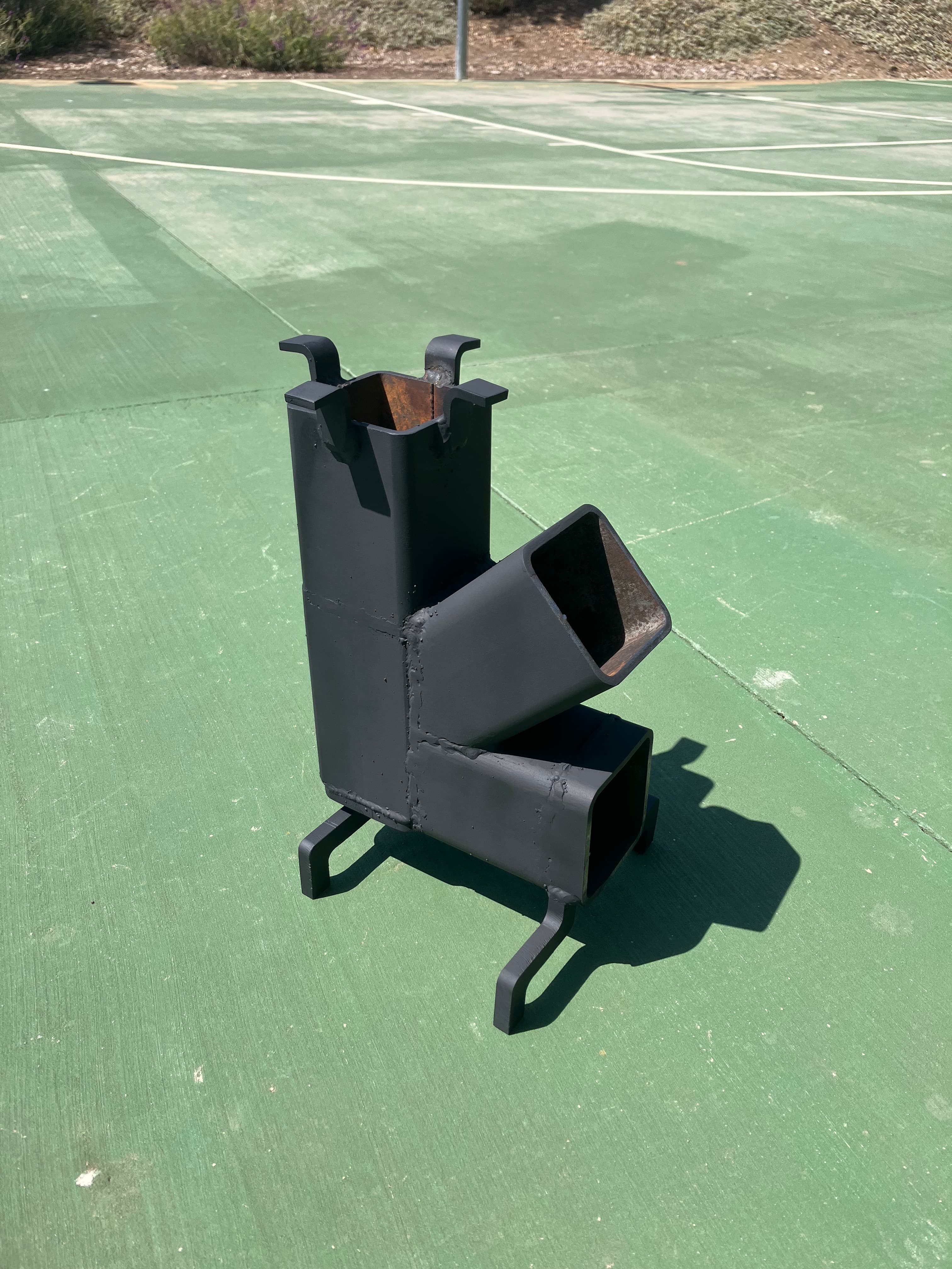 Completed wood-burning rocket stove during operation